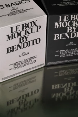 Two boxes with bold black text reading Le Box Mockup by Bendito stand side by side; one box is white, the other black, both with specs and smaller text below, reflected on a shiny surface.