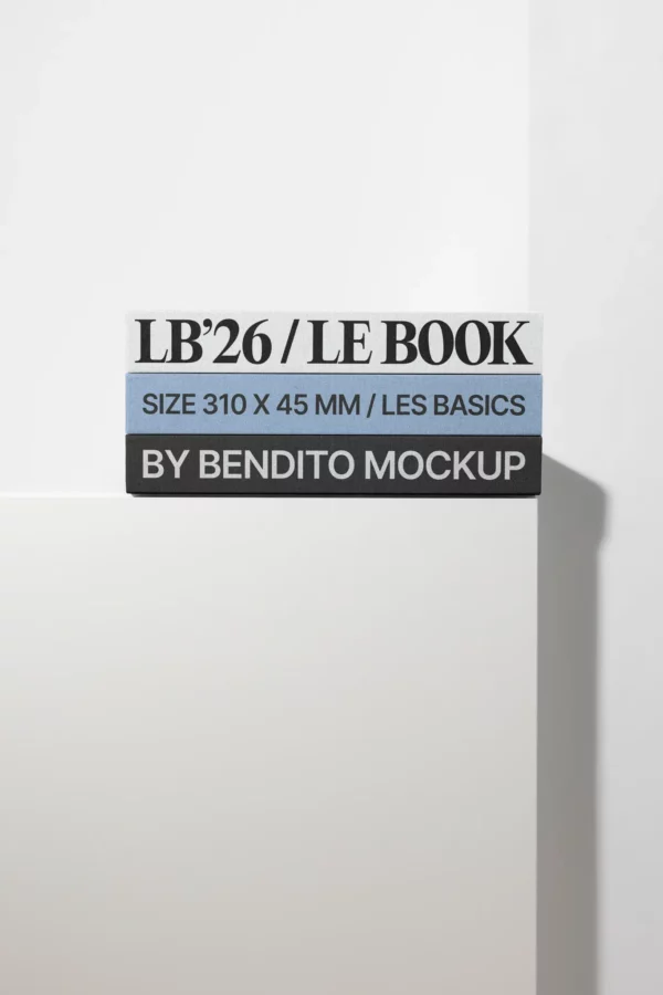 A stack of three books with spines reading “LB’26 / LE BOOK,” “SIZE 310 X 45 MM / LES BASICS,” and “BY BENDITO MOCKUP,” resting on a white surface against a light background.