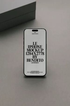 A modern smartphone standing upright on a gray surface, displaying bold black text about an iPhone mockup with the dimensions 1284x2778 px. A gray box is partially visible in the background.