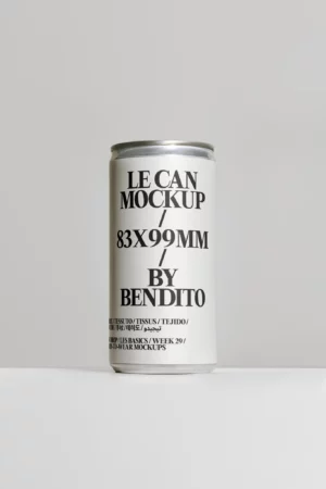 A silver beverage can stands upright against a light grey background. Its white label features bold black text that reads, LE CAN MOCKUP / 83X99MM BY BENDITO, along with smaller text at the bottom.