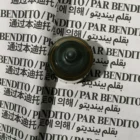 A brass object placed on a wrinkled sheet printed with the phrase PAR BENDITO in multiple languages, including English, Chinese, Korean, and Arabic, repeated in bold black letters.