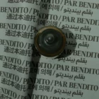 A metallic door knocker is placed on a sheet of paper printed repeatedly with the phrase “PAR BENDITO” in various languages, including English, Chinese, Korean, and Arabic. The paper appears slightly folded.