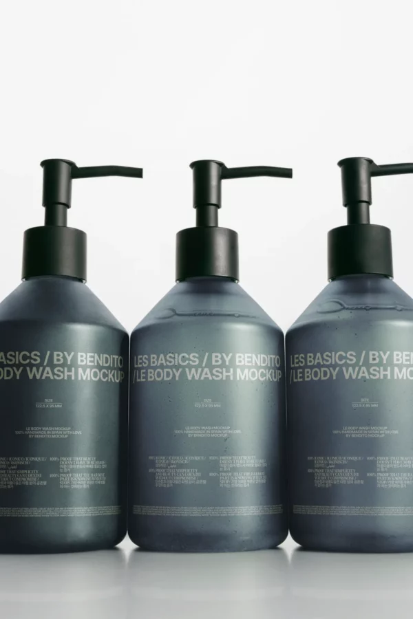 Three dark gray pump bottles labeled LES BASICS / BY BENDITO LE BODY WASH MOCKUP are lined up side by side against a white background.